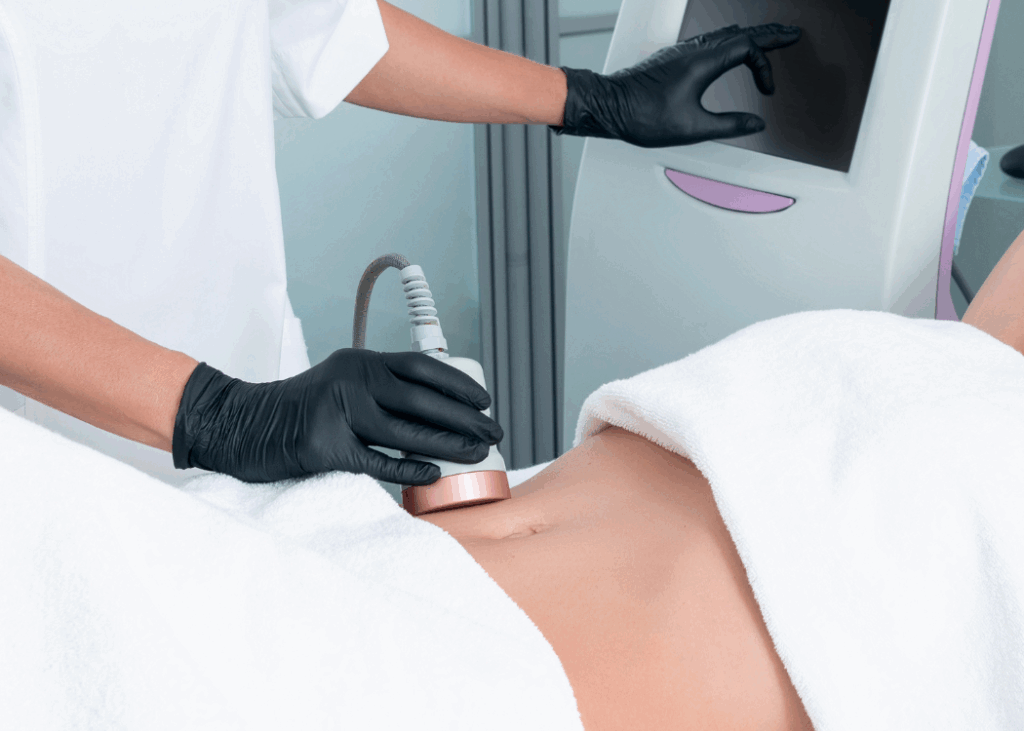 A woman lies on a treatment table while receiving laser therapy on her stomach, with medical equipment visible nearby.