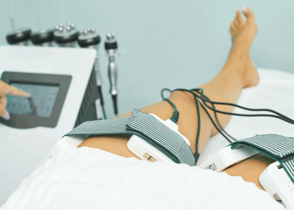 A person utilizing an electric device on their legs, aimed at improving circulation and relieving discomfort.