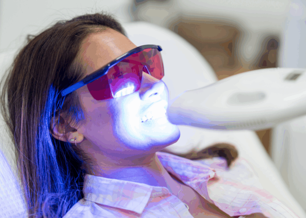 a women having her dental spa by making her teeth white using infrared Lights