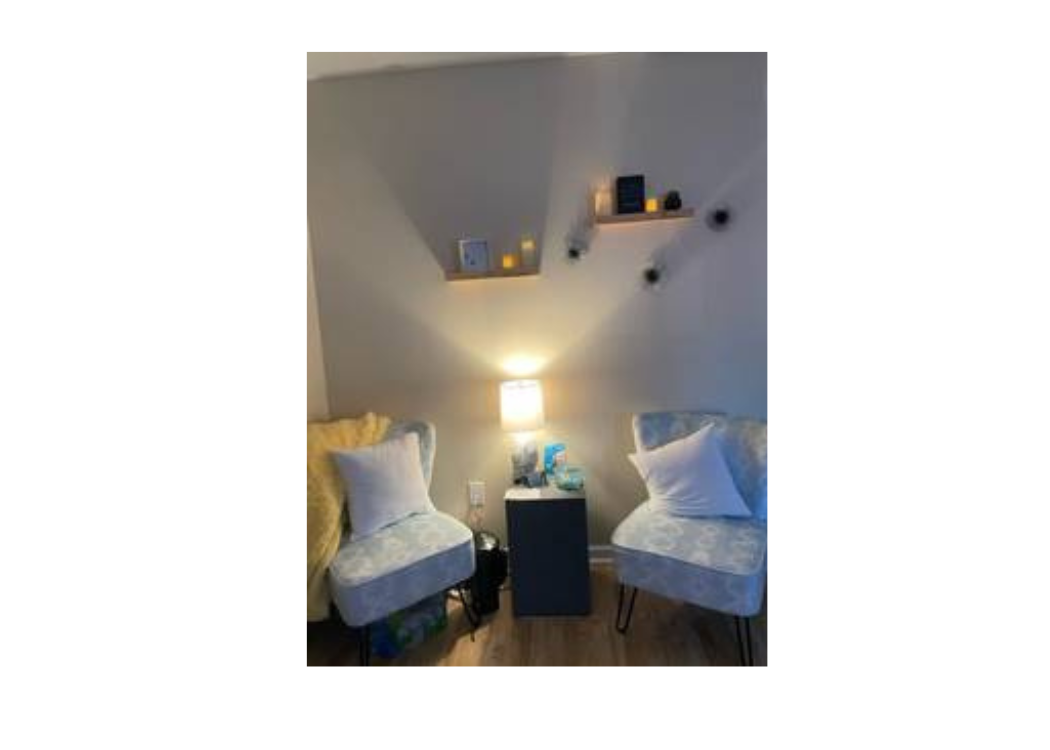 A small room featuring two chairs and a lamp, creating a cozy and inviting atmosphere.